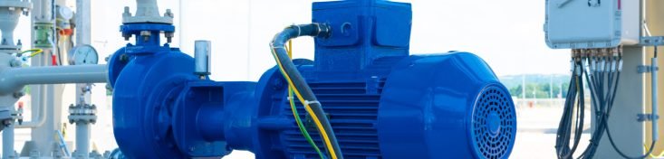 Blue electric water pump mounted on a concrete base.